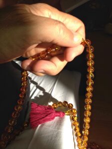 Hand holding prayer beads
